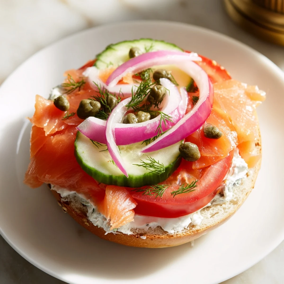 Golden brown baked salmon flakes easily atop a toasted bagel spread with creamy herbed cheese for this Baked Salmon Brunch Bagel.