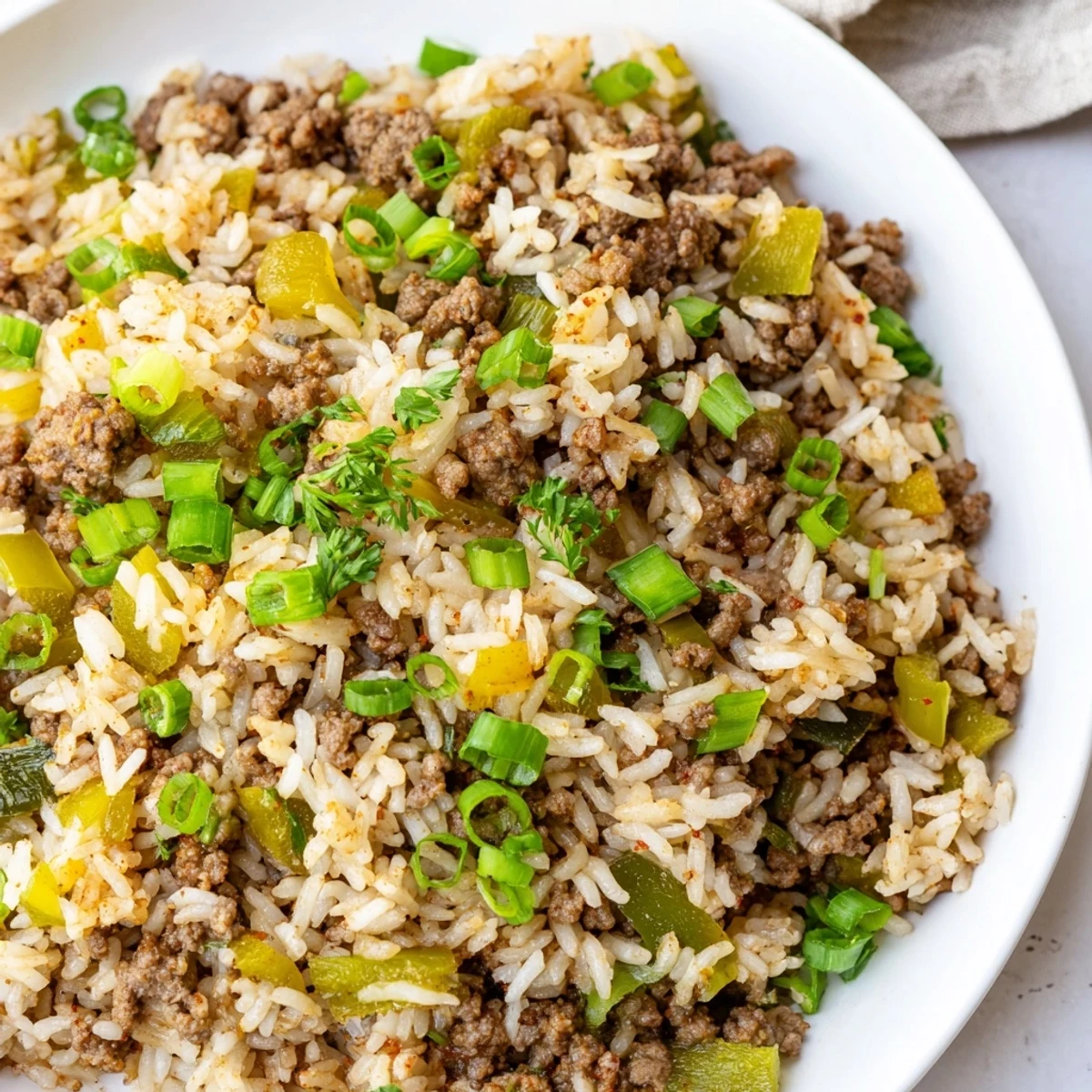 Steaming skillet of Cajun Dirty Rice with ground beef, showcasing the rich, savory texture of this classic Louisiana main dish.