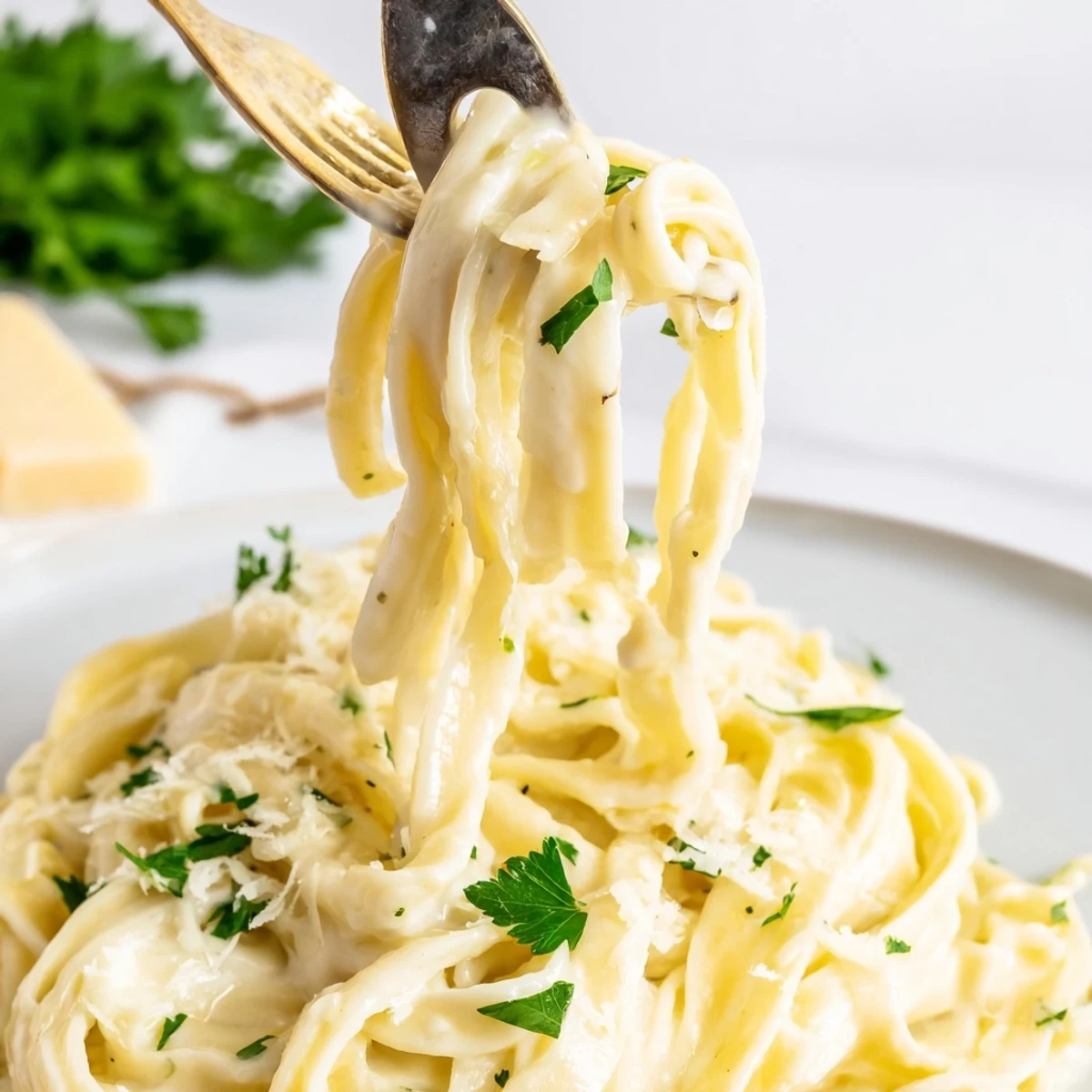 Homemade Creamy Garlic Pasta with Parsley on a rustic table, garnished with chopped parsley and a glass of crisp white wine, ready for a comforting dinner.