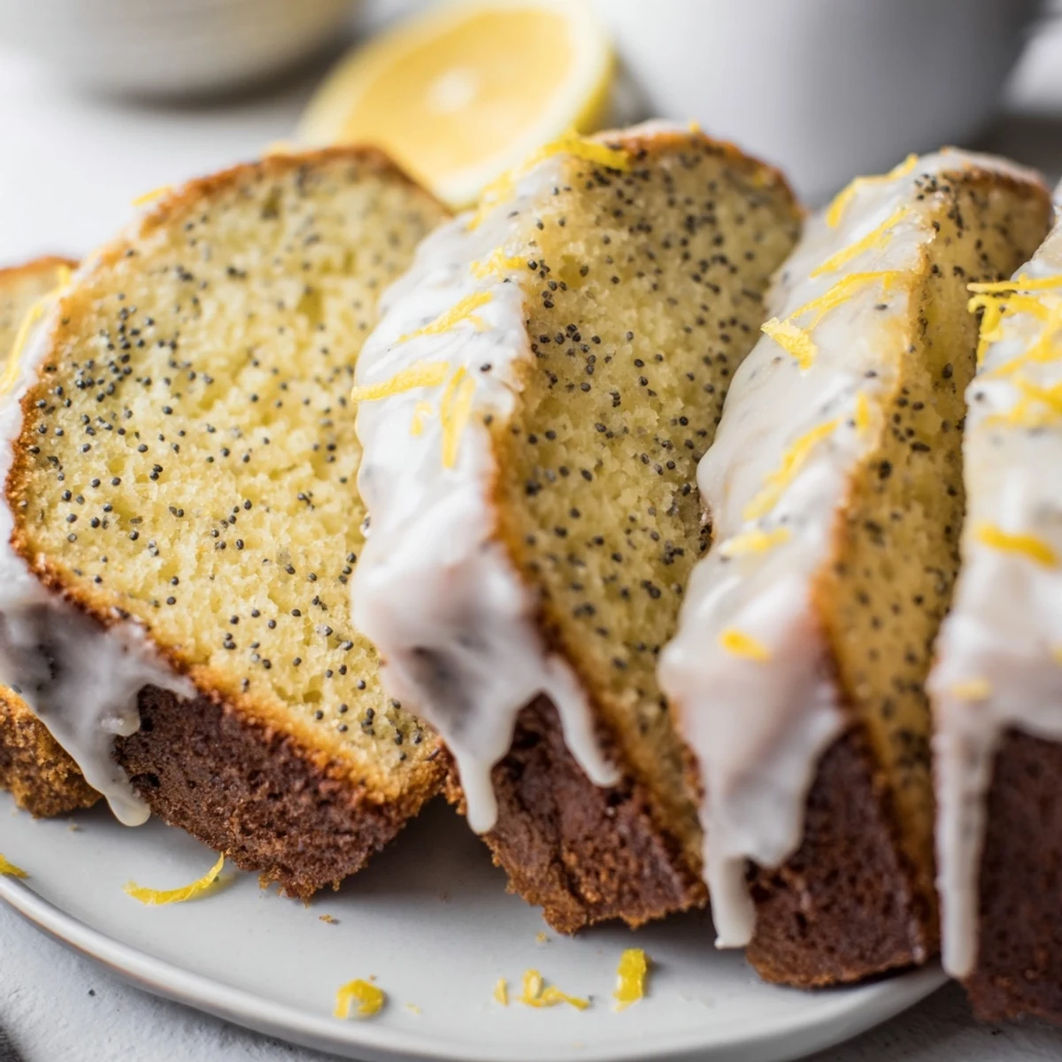 Freshly baked Lemon Poppy Seed Loaf glistening with a sweet lemon glaze on a cooling rack.