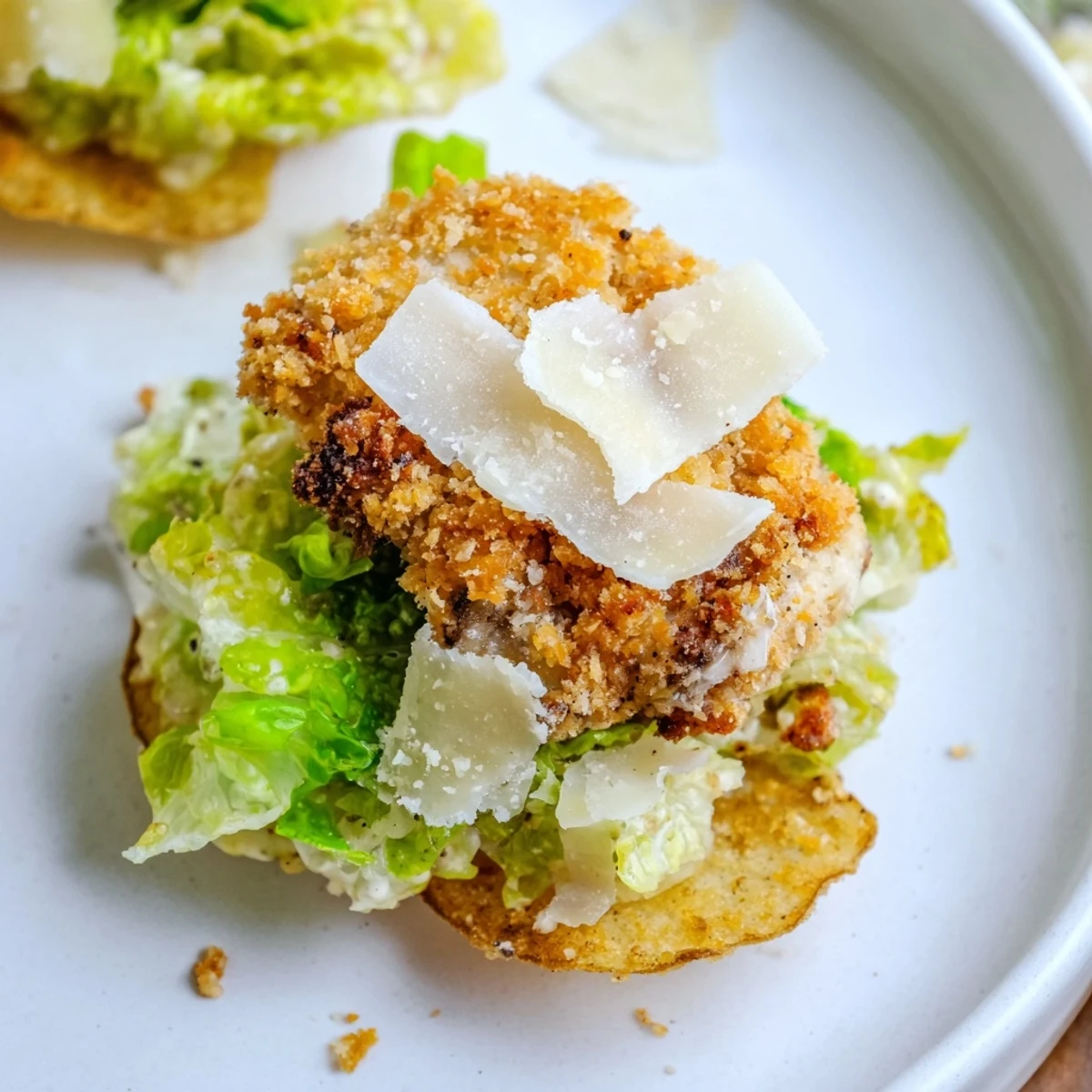 Crispy Chicken Caesar Salad Chips served on a platter with lemon wedges, showcasing a fun twist on classic Caesar salad flavors.
