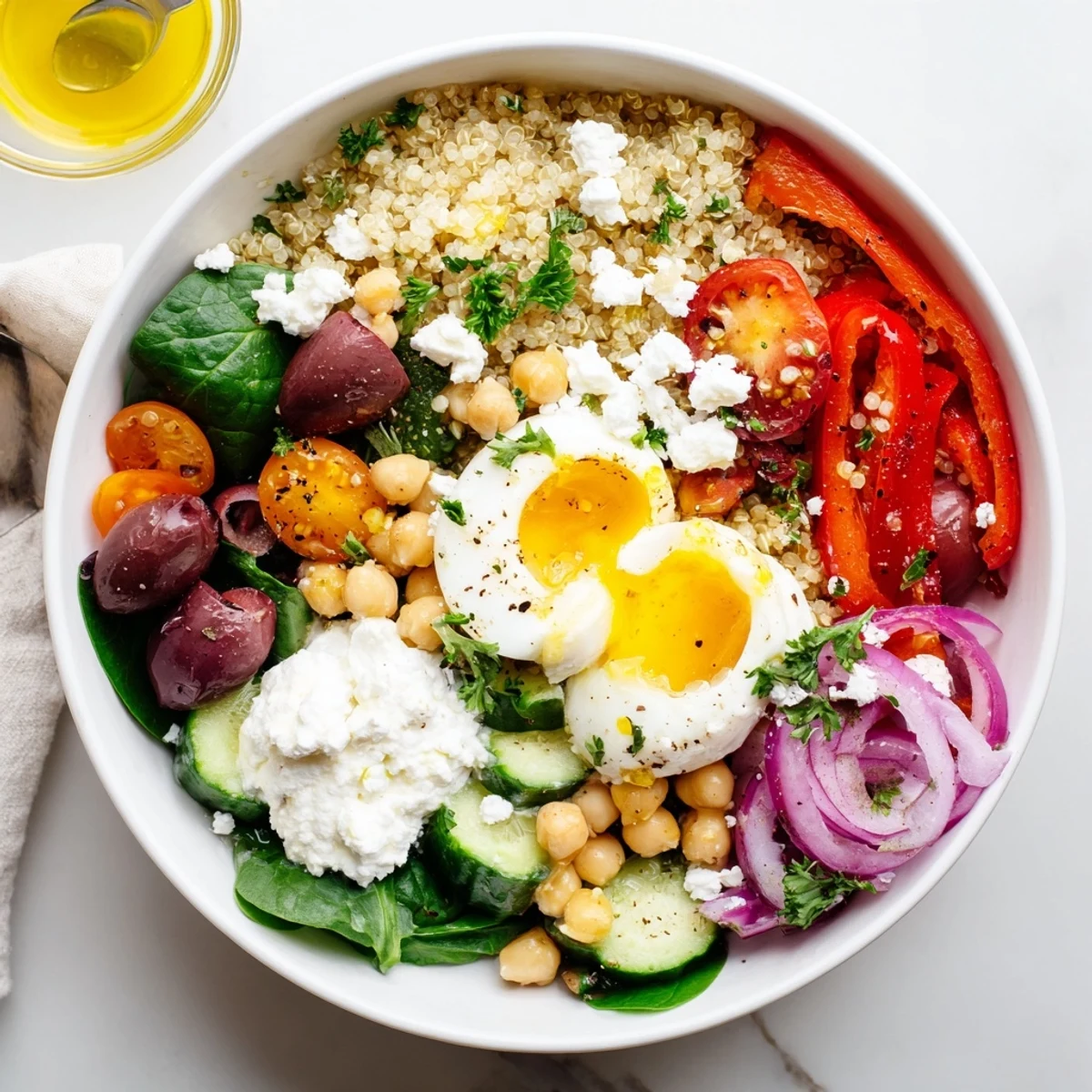 Serving suggestion for High Protein Mediterranean Breakfast Bowls shows the meal prep ready for a quick morning, with lemon wedges on the side and spinach leaves adding green freshness.