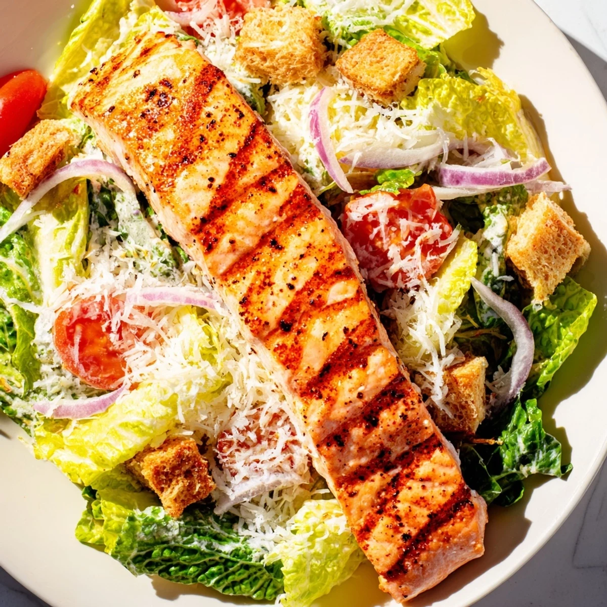 Succulent seasoned grilled salmon fillet served on a bed of crunchy romaine with homemade Caesar dressing and croutons