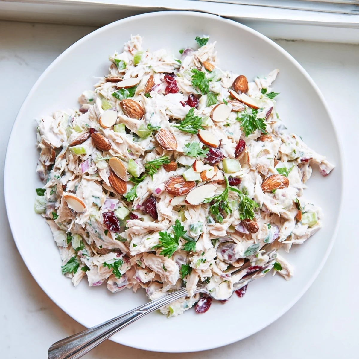 Creamy Greek yogurt rotisserie chicken salad with crisp celery, red bell pepper, and fresh herbs