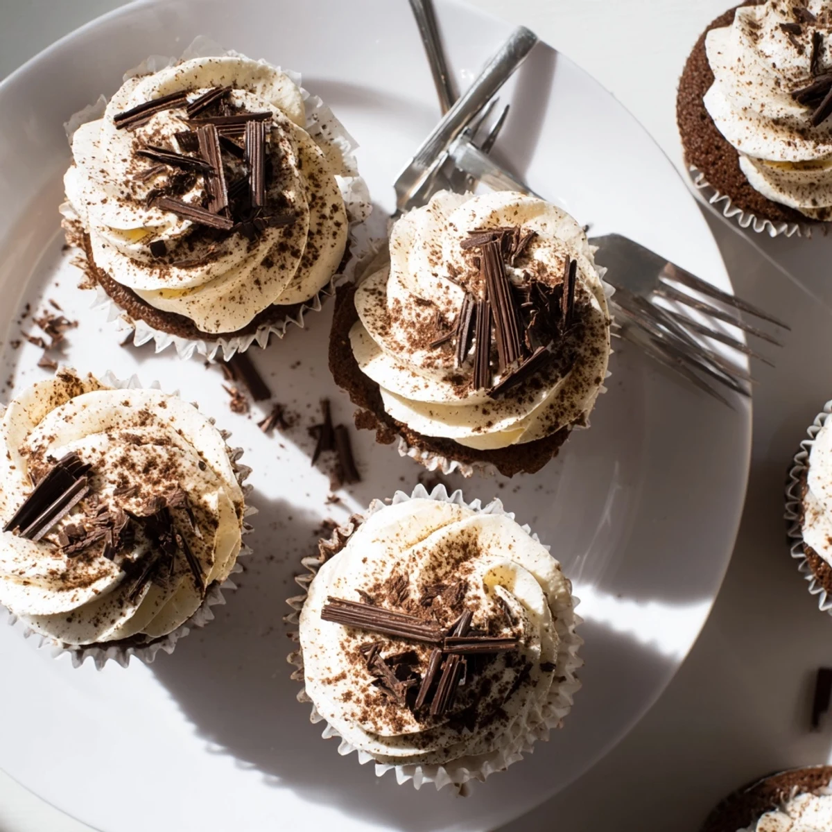 Decadent chocolate tiramisu cupcakes topped with fluffy mascarpone frosting and dusted cocoa powder