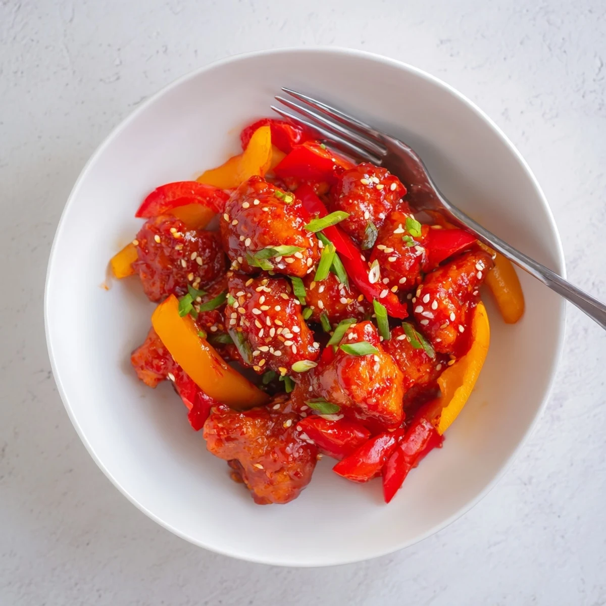 Sizzling spicy dragon chicken stir-fried with vibrant peppers and aromatic garlic in a wok