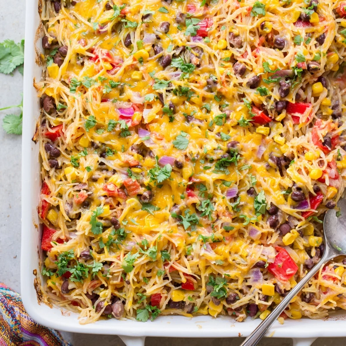 Golden melted cheese tops this Mexican spaghetti squash casserole with black beans and roasted vegetables