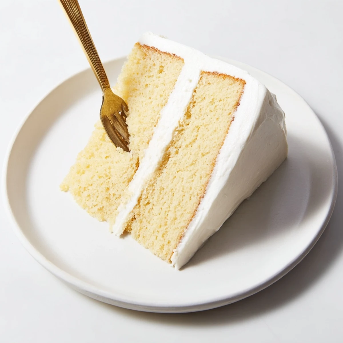Frosted church cake close-up showing moist vanilla layers and sprinkled coconut topping