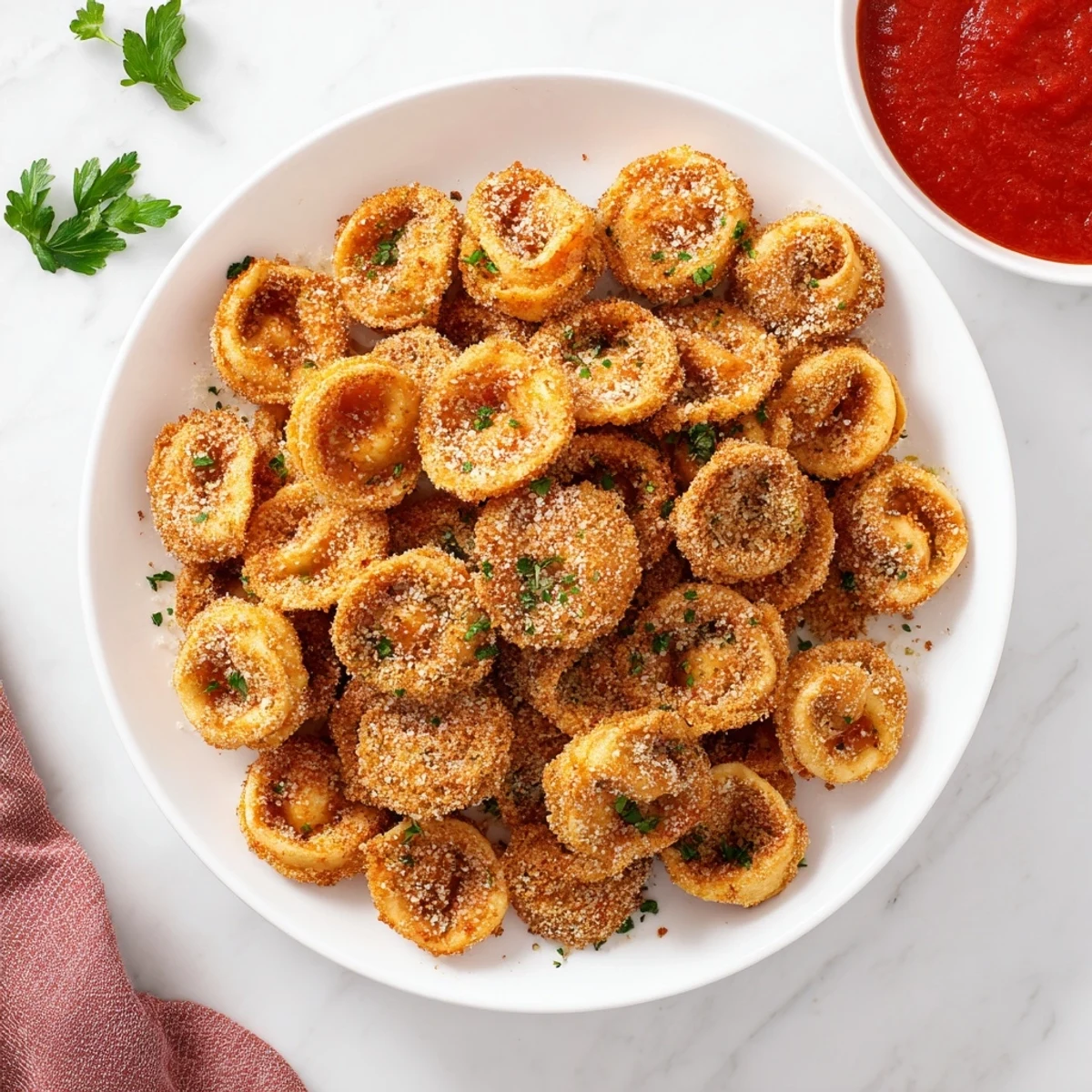 Crispy breadcrumb-coated tortellini bites fresh from the air fryer basket, perfectly golden and ready for snacking