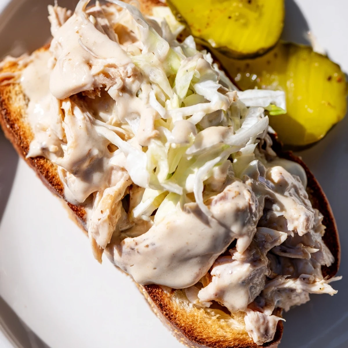 Tender smoked chicken draped in tangy white Alabama BBQ sauce with crunchy coleslaw