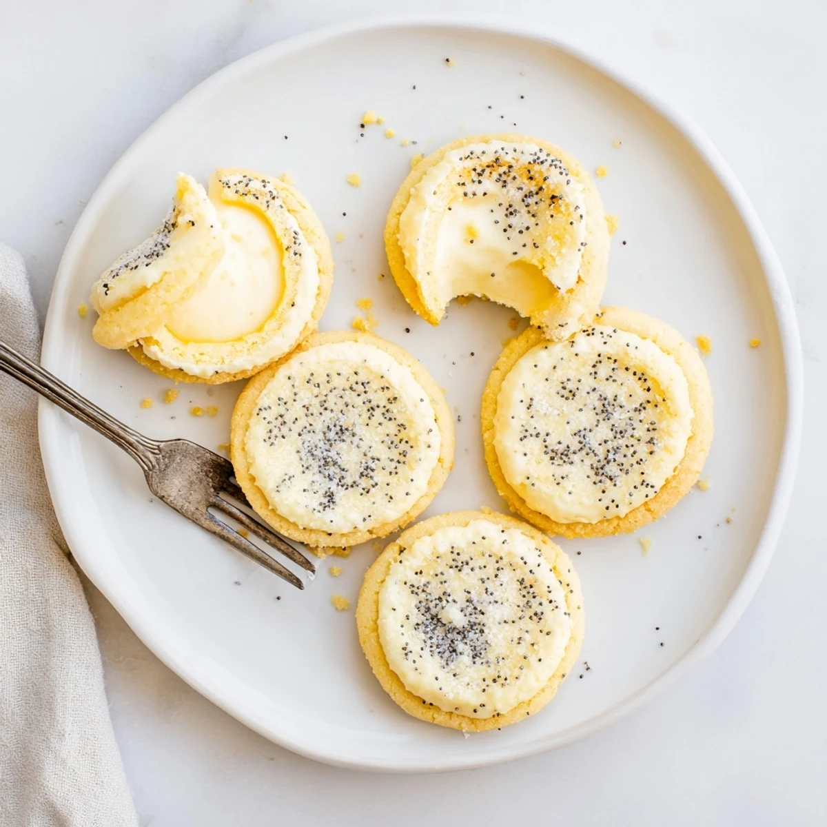 Baked lemon poppy seed cheesecake cookies oozing with sweet cream cheese filling