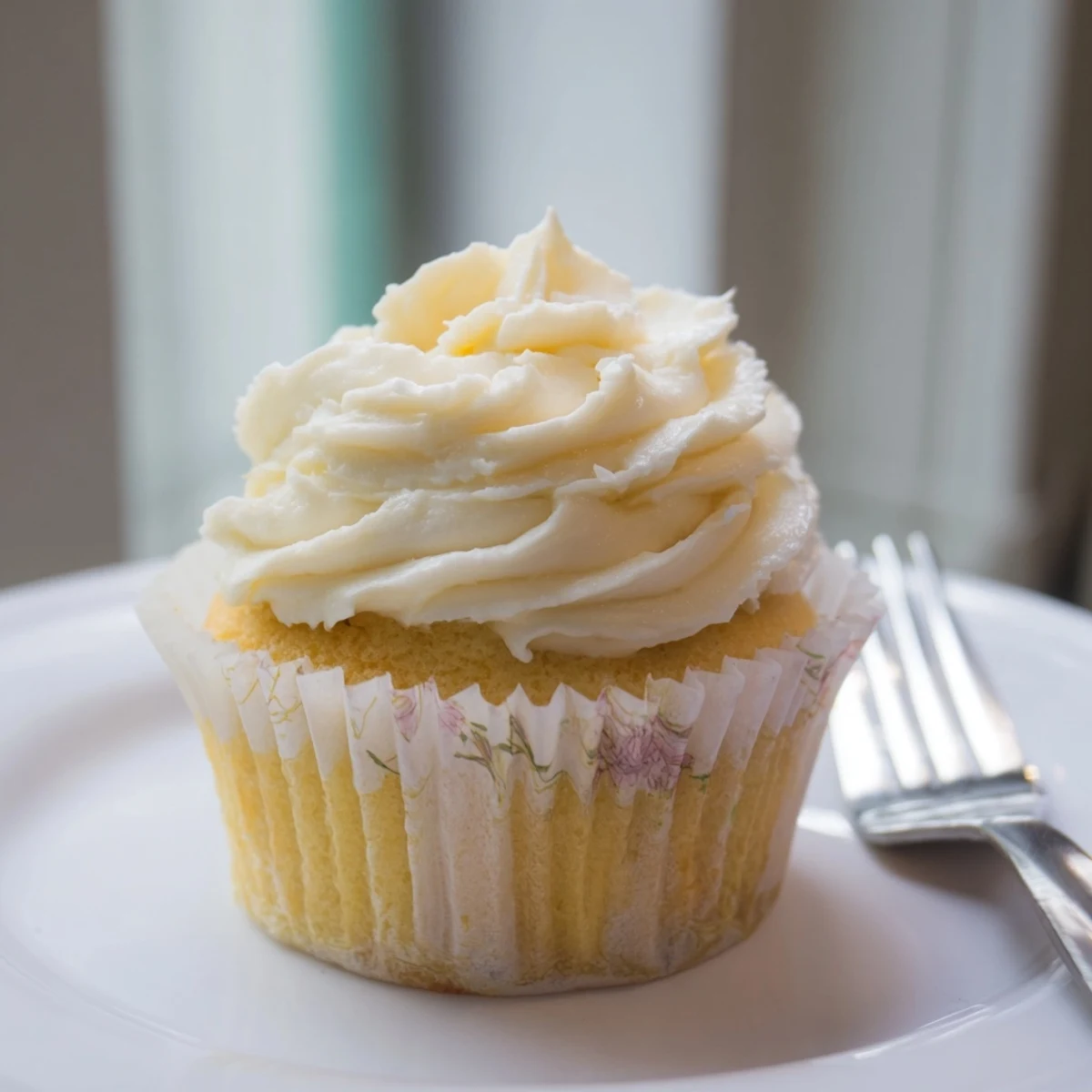 Light and fluffy vanilla cupcakes with swirls of creamy vanilla frosting and colorful sprinkles