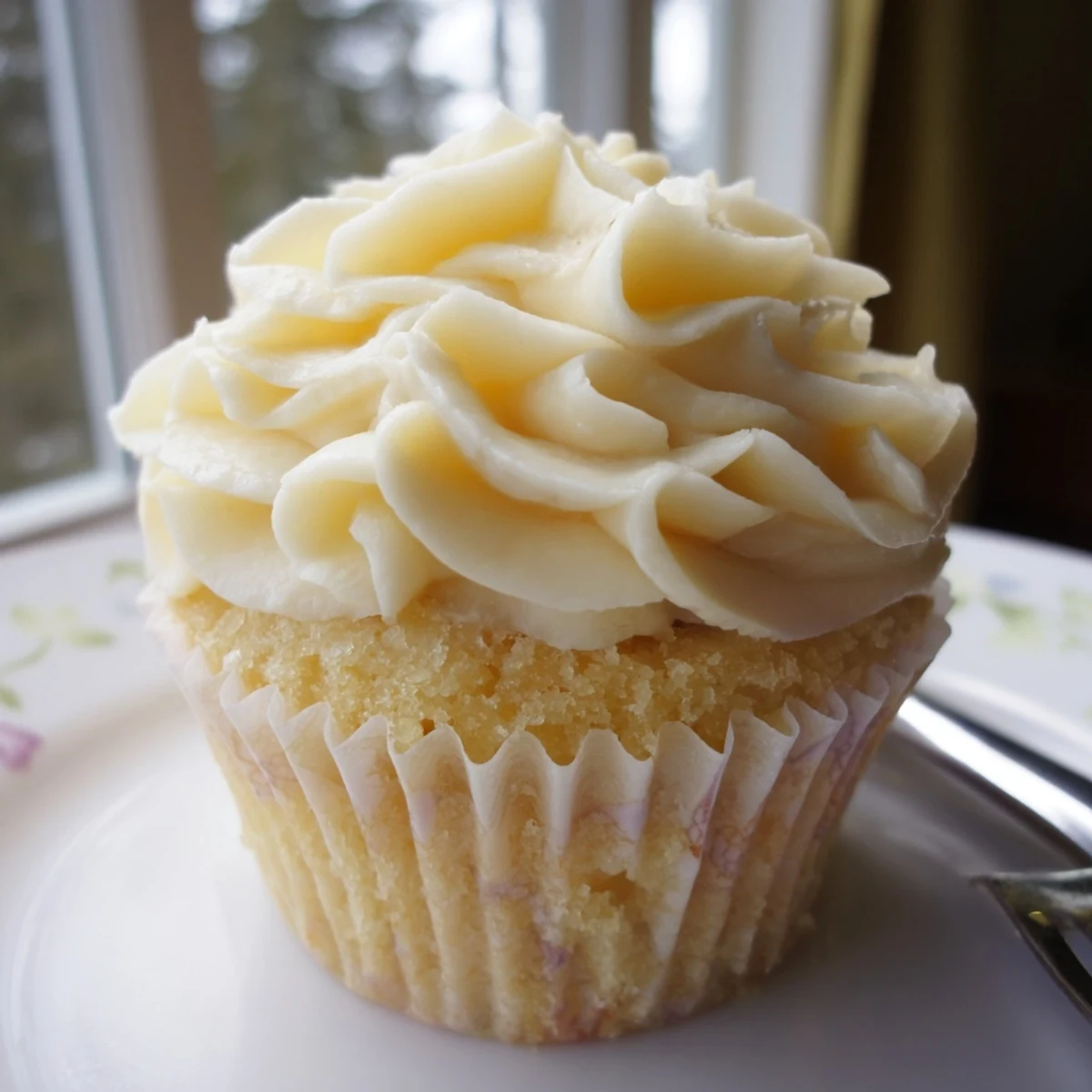 Classic vanilla cupcakes with tall peaks of sweet buttercream frosting, perfect for birthday celebrations
