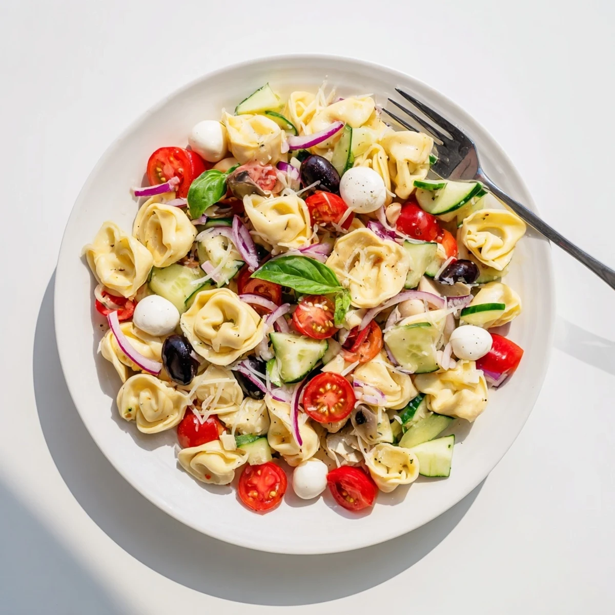 Creamy cheese tortellini salad tossed with crisp vegetables and herbs for a fresh summer dish