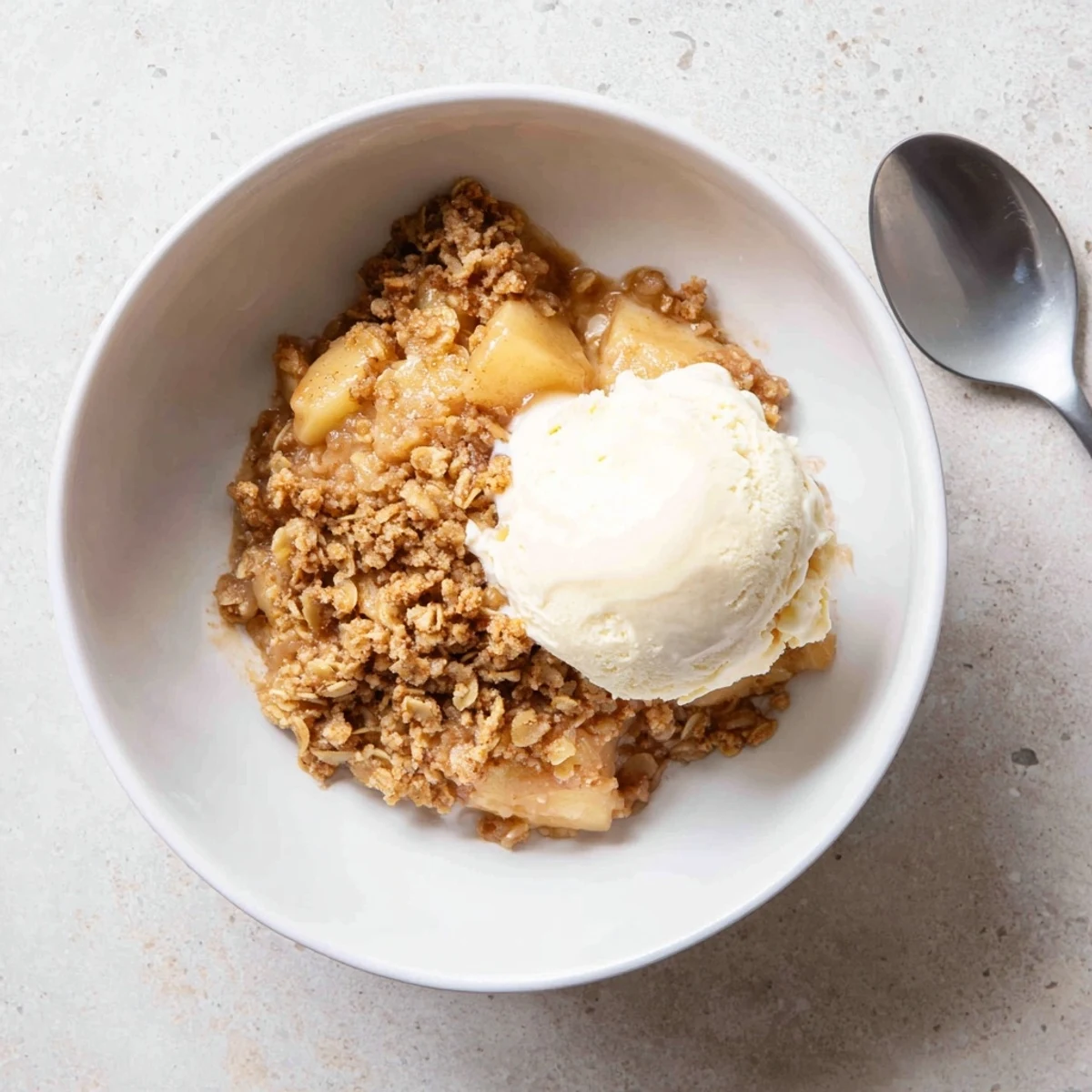 Crockpot apple crisp featuring tender spiced apple slices under a buttery brown sugar crust