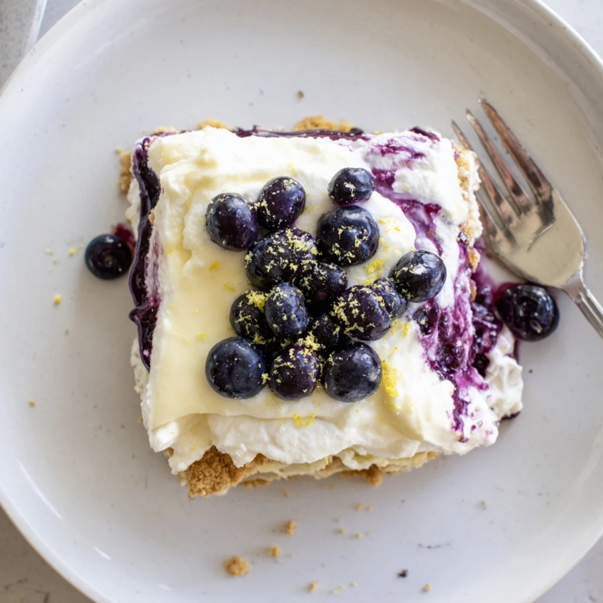 A chilled lemon blueberry lasagna recipe with layered creamy filling and purple berry swirls