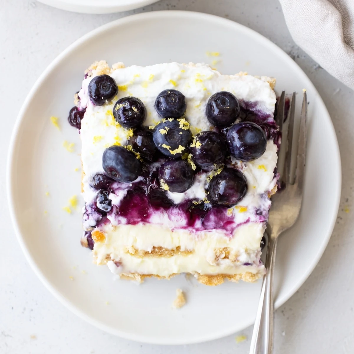 No-bake lemon blueberry lasagna recipe showing golden cookie crust beneath bright fruit layers