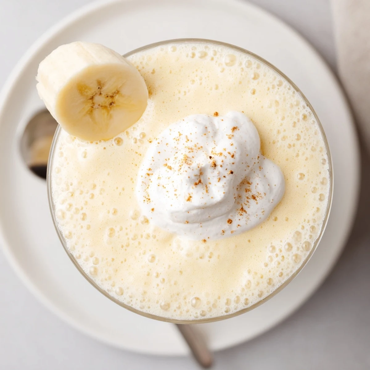 Creamy Vanilla Banana Shake blended with maple syrup, cinnamon sprinkle