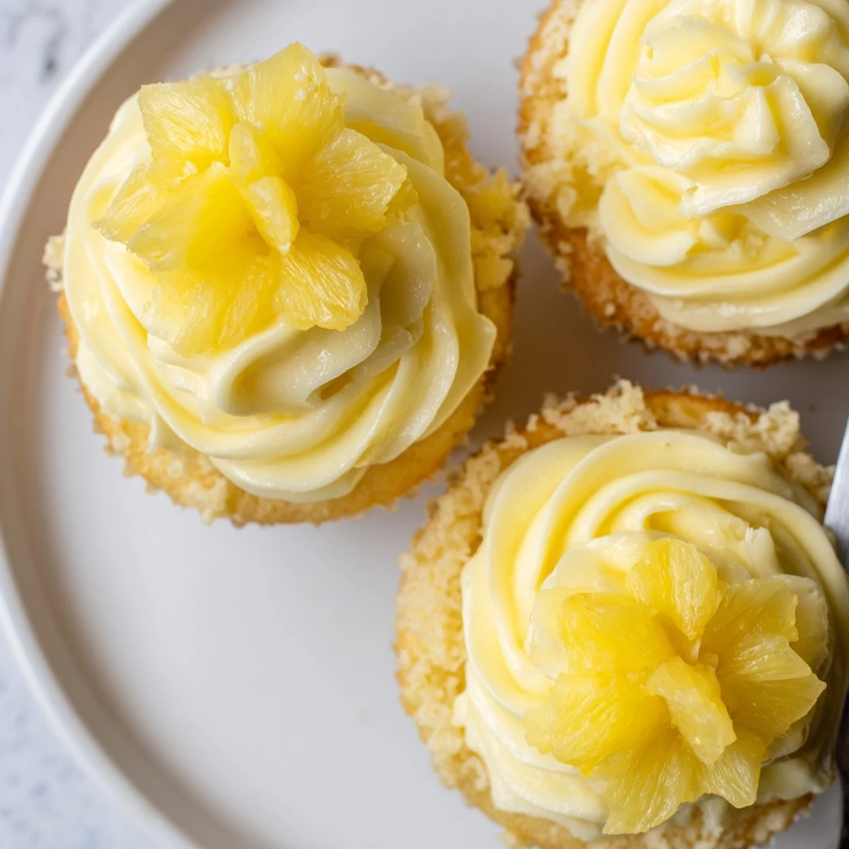 Dole Whip Cupcakes Recipe: fluffy pineapple cupcakes topped with creamy yellow frosting
