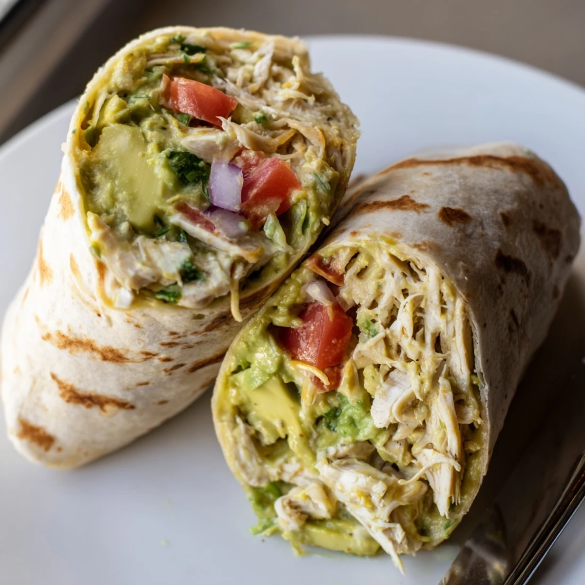 Warm Chicken Avocado Ranch Burritos with crisp tortilla edges and creamy drizzle
