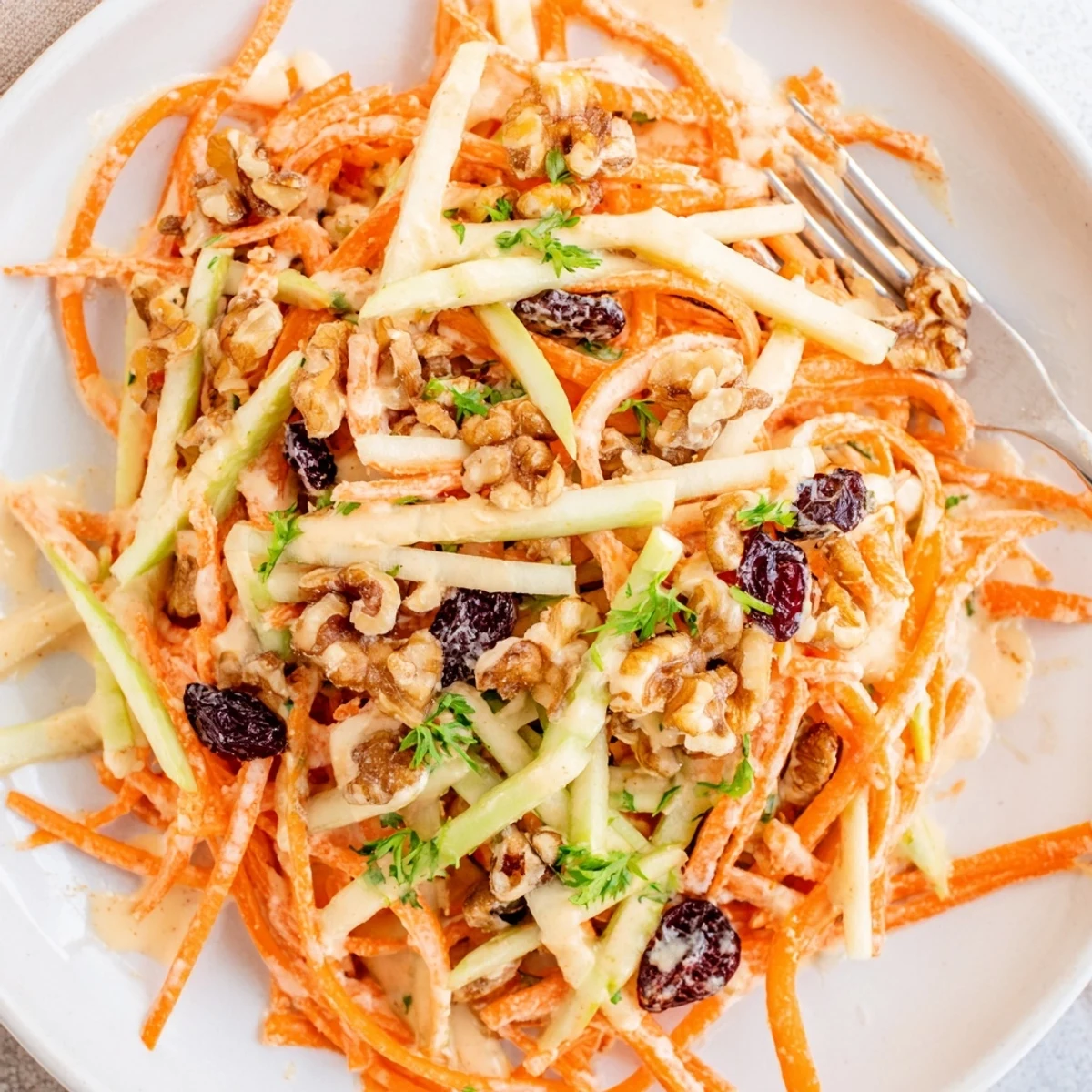 A bowl of Crunchy Apple Carrot Salad With Creamy Citrus Dressing, tangy, creamy, refreshing