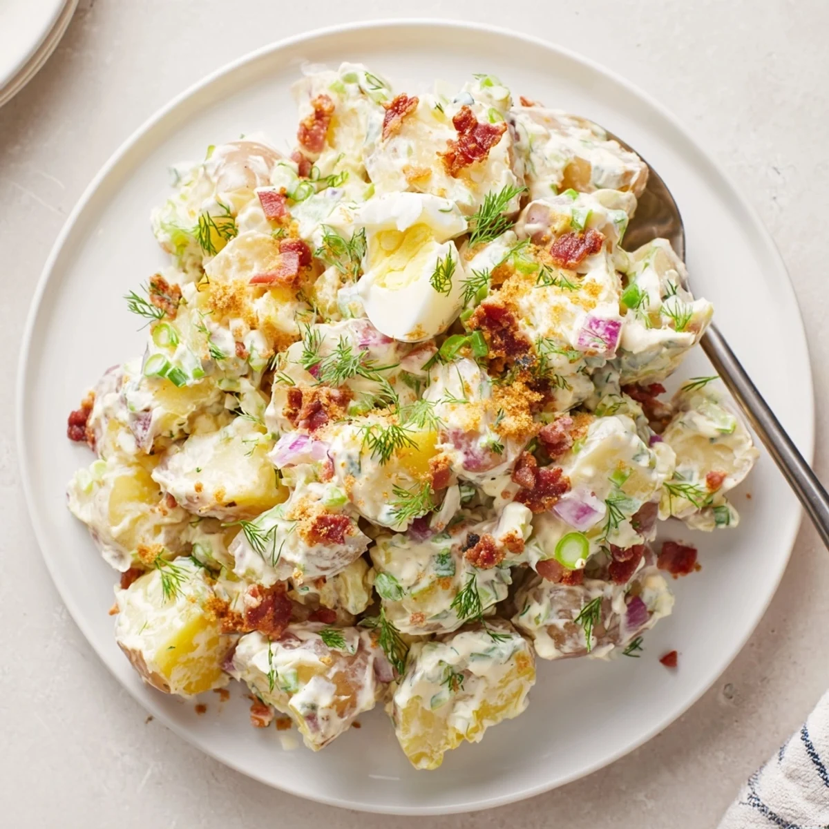 Cold Steakhouse Potato Salad, silky mayo dressing, smoky paprika, served at barbecue.