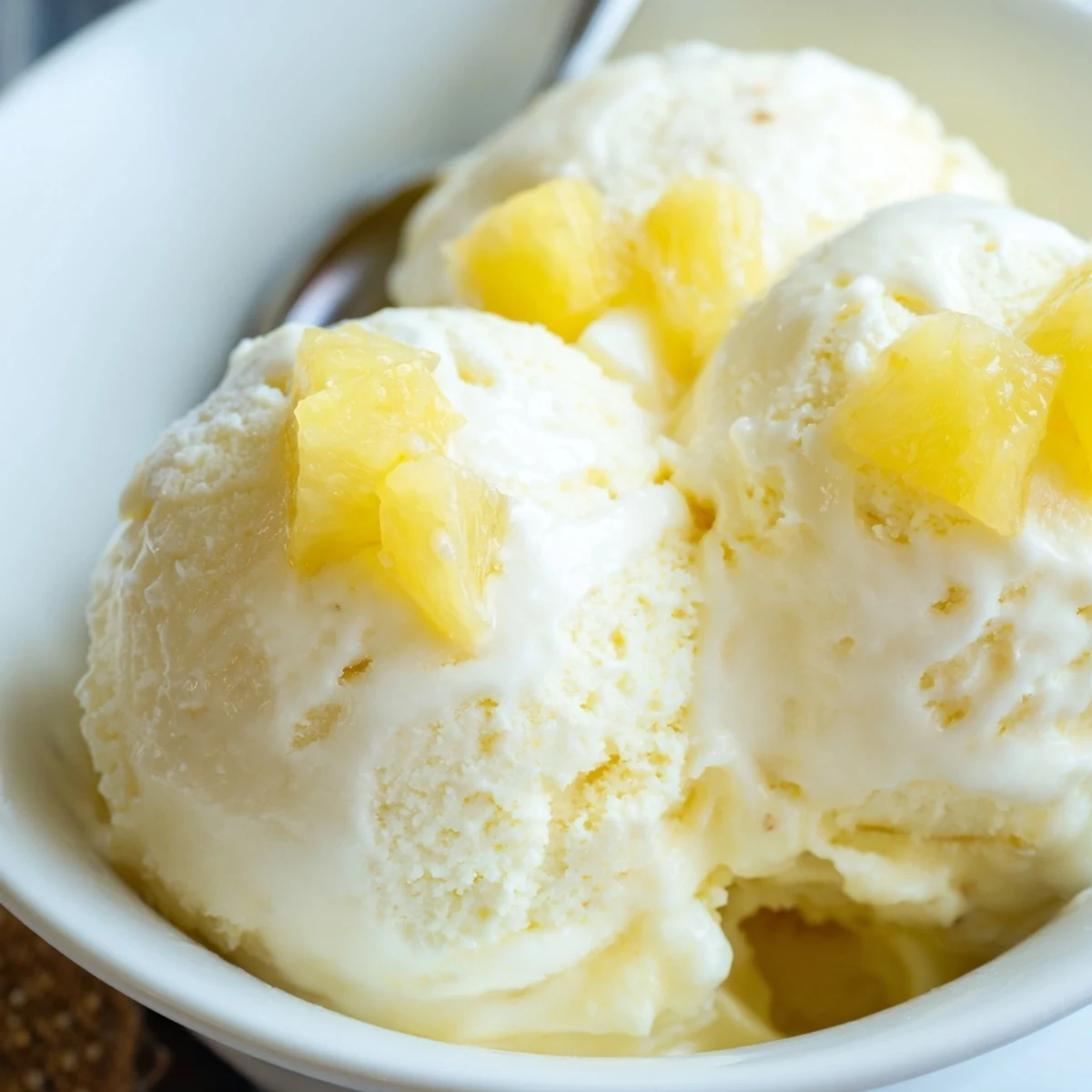Serve Creamy Pineapple Ice Cream Recipe in bowls with toasted coconut garnish