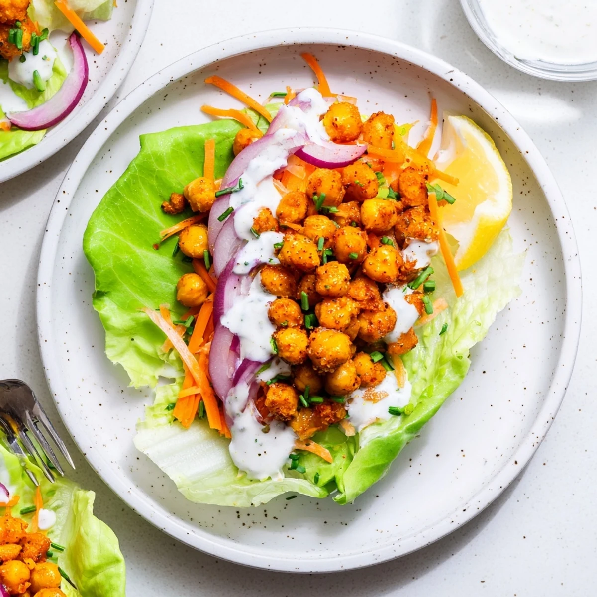 Buffalo Chickpea Lettuce Wraps with spicy chickpeas, crisp carrots, cooling ranch drizzle