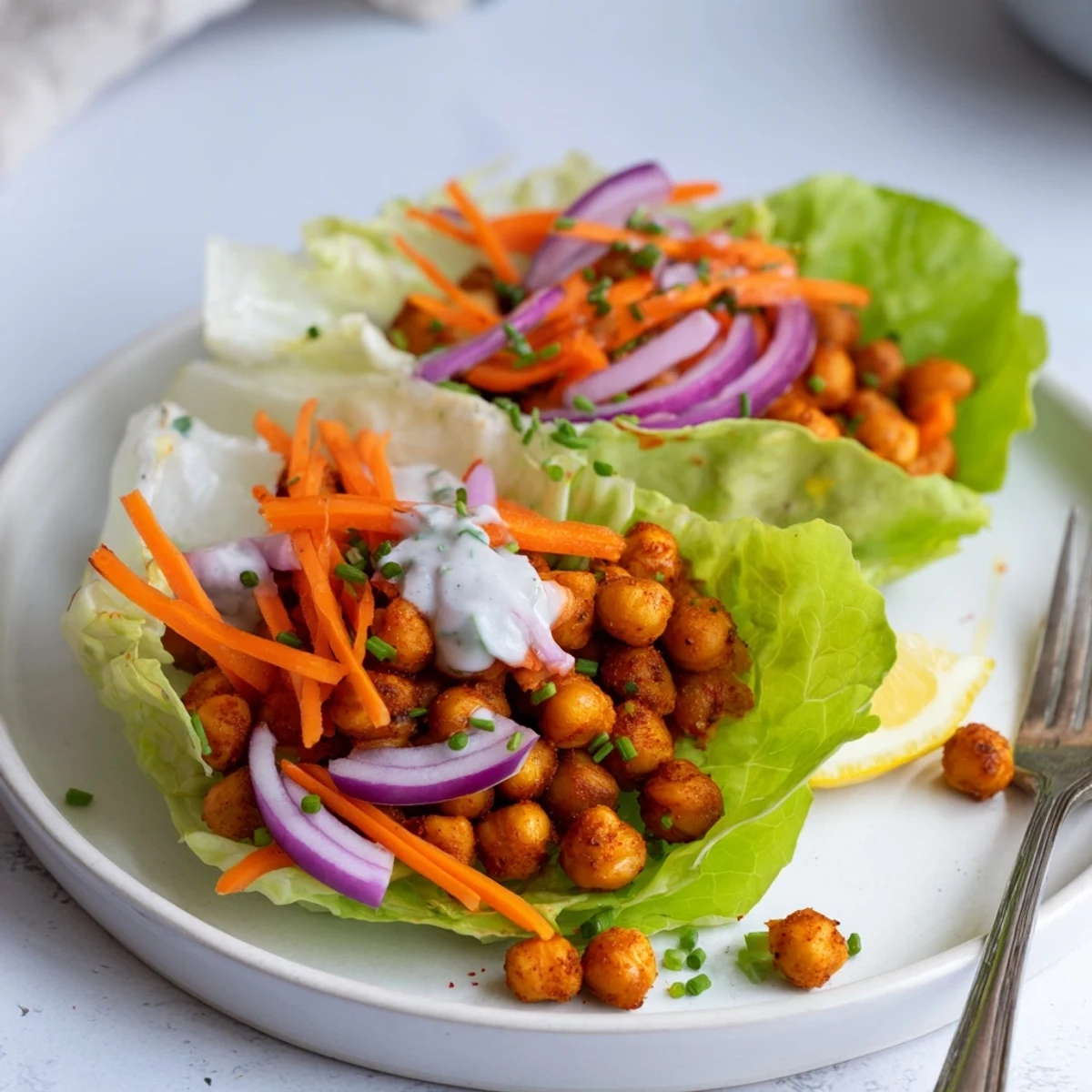 Bright platter of Buffalo Chickpea Lettuce Wraps with zesty crunchy filling
