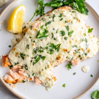 Tender baked salmon topped with melted herbed Boursin cheese and bright parsley