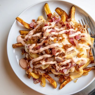 Golden cheesy In N Out Animal Style Fries topped with caramelized onions and sauce